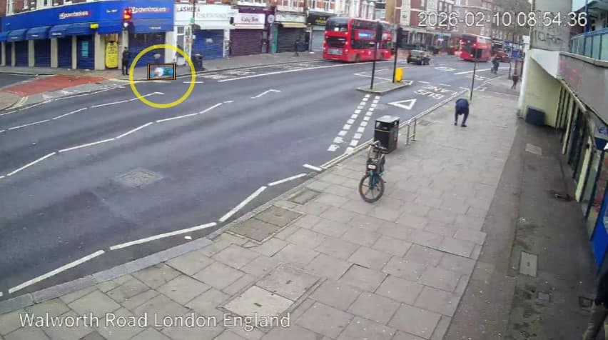 Street camera frame with dumped waste circled on the pavement, stamped with the date and time